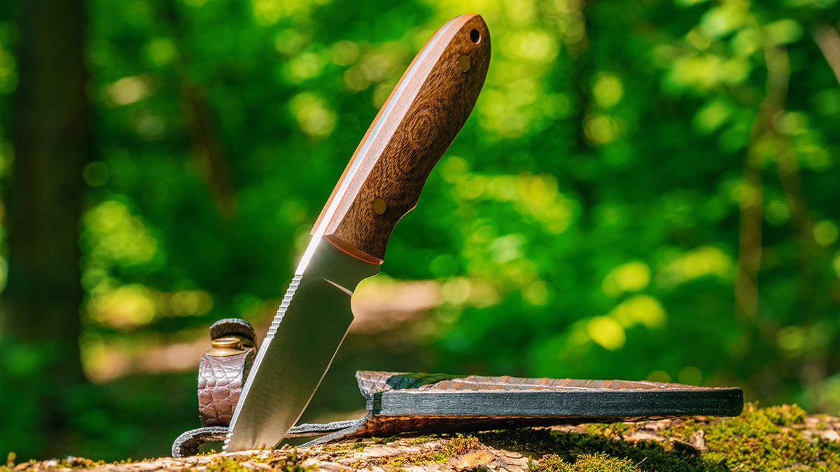 A knife with a wooden handle sticking out of a tree log.