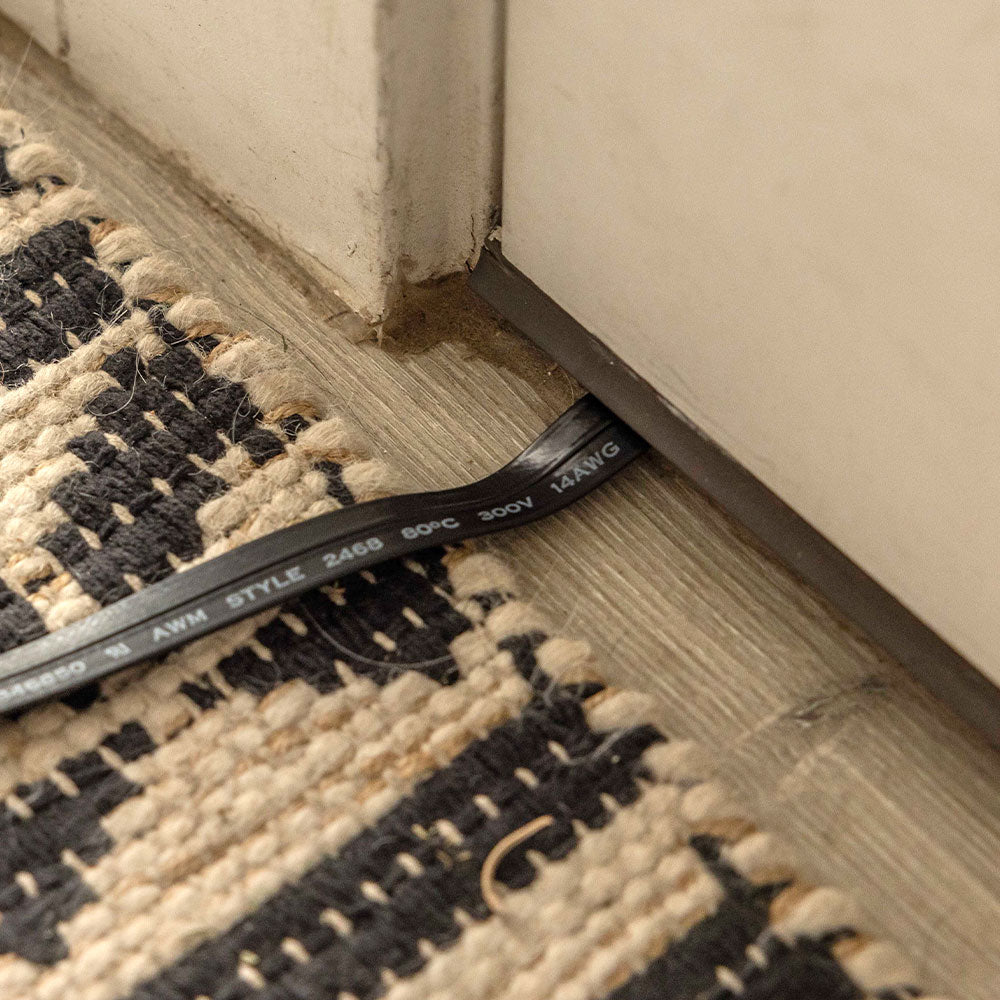 Extension cord running under a door