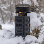 InstaFire Inferno Pro stove with a pot on top, operating in snowy conditions