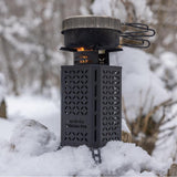 InstaFire Inferno Pro stove with a pot on top, operating in snowy conditions