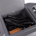 Open compartment on top of a 2200 battery revealing neatly organized storage space for charging cords, highlighting the battery's convenient design for cable management.