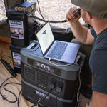 Individual indoors powering a laptop with one Grid Doctor 2200 battery and one 2200XP battery. 